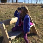 girl sitting with binoculars